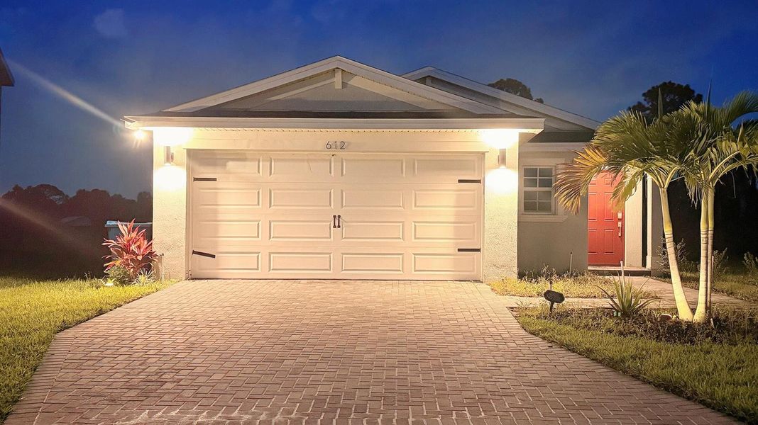 Front exterior of a new home in , Palm Bay, FL, highlighting curb appeal (Image 1).