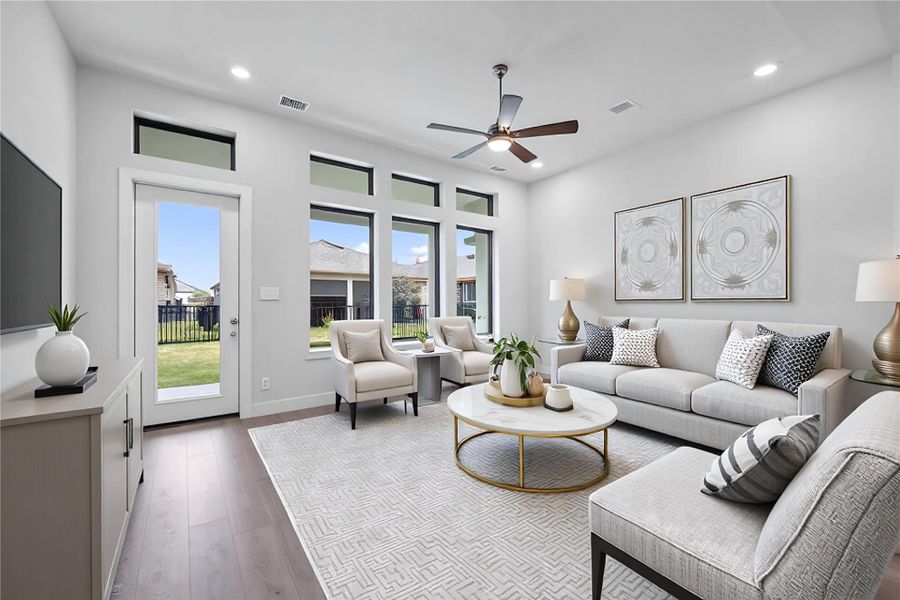 The great room features tall ceilings, ceiling fan, abundant natural light with plenty of windows, and an open, inviting ambiance--perfect for gatherings, relaxation, and making memories. *Virtually Staged