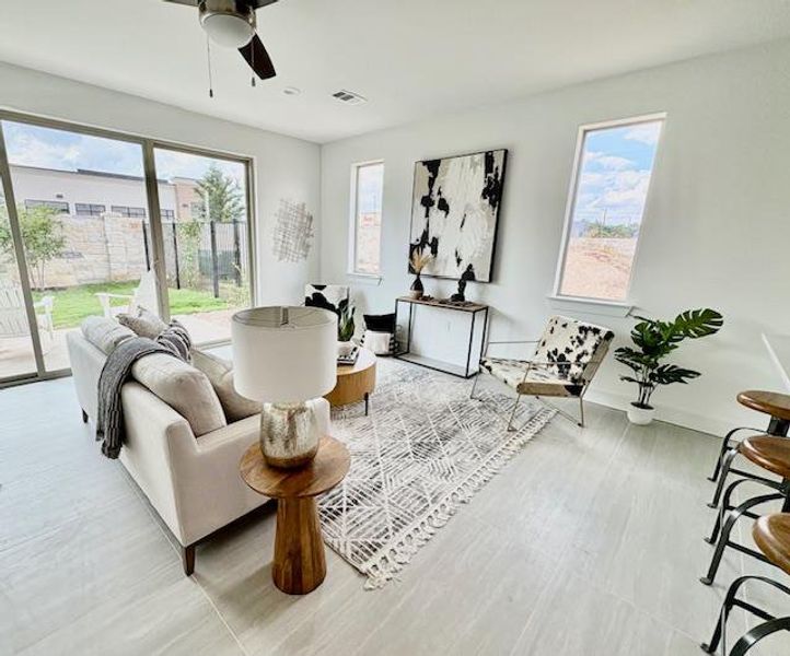 Sitting room with ceiling fan and baseboards