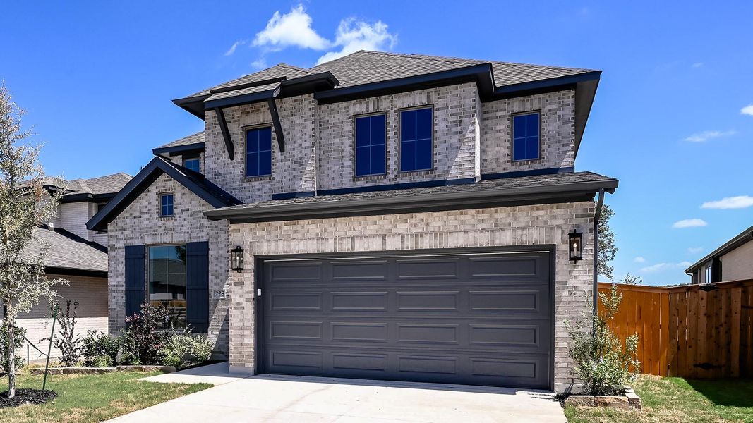 Front exterior of a new home in 6 Creeks, Kyle, TX, highlighting curb appeal (Image 18).