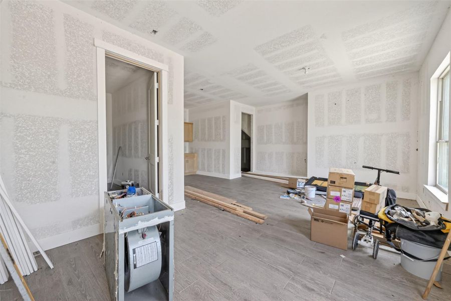 Main-level interior featuring unfinished drywall, open layout, and construction in progress.
