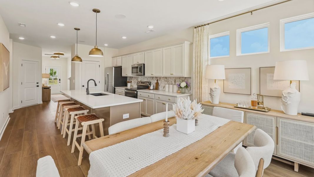 Kitchen with tile backsplash, pendant lighting, and quartz countertops