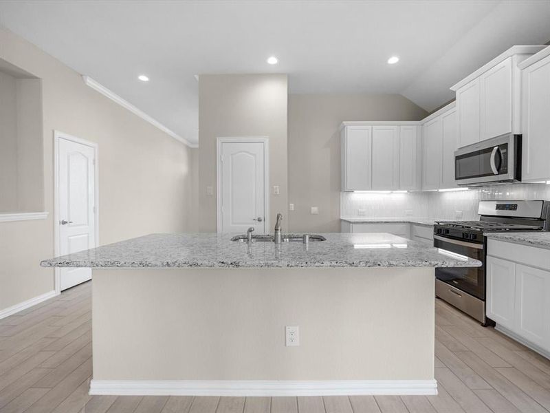 A kitchen with white cabinets. A kitchen with white cabinets.