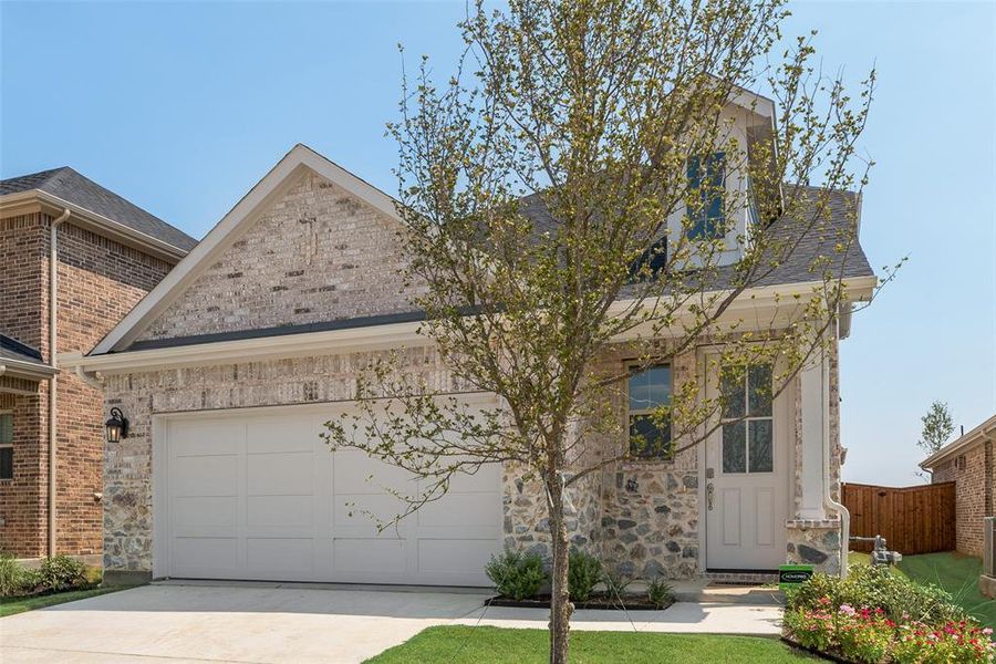 Front exterior of a new home in Spiritas Ranch, Little Elm, TX, highlighting curb appeal (Image 1). Front exterior of a new home in Spiritas Ranch, Little Elm, TX, highlighting curb appeal (Image 1).