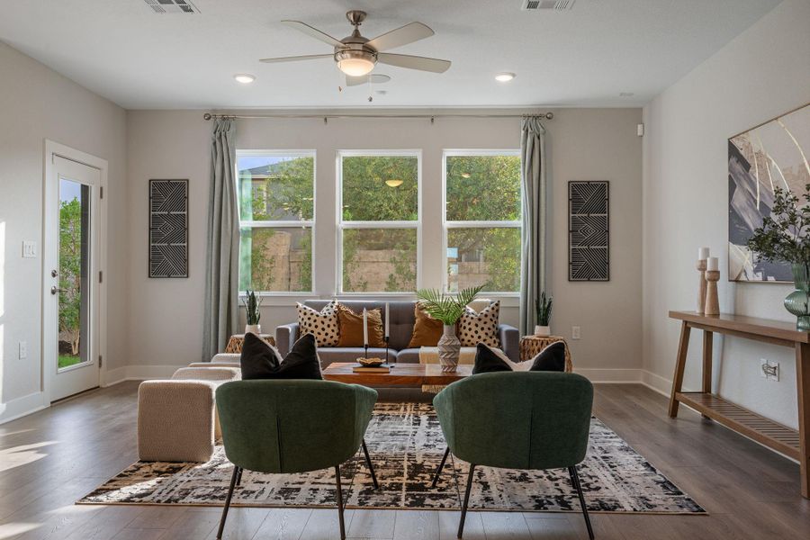 Spacious living area with great natural lighting & custom window curtains.