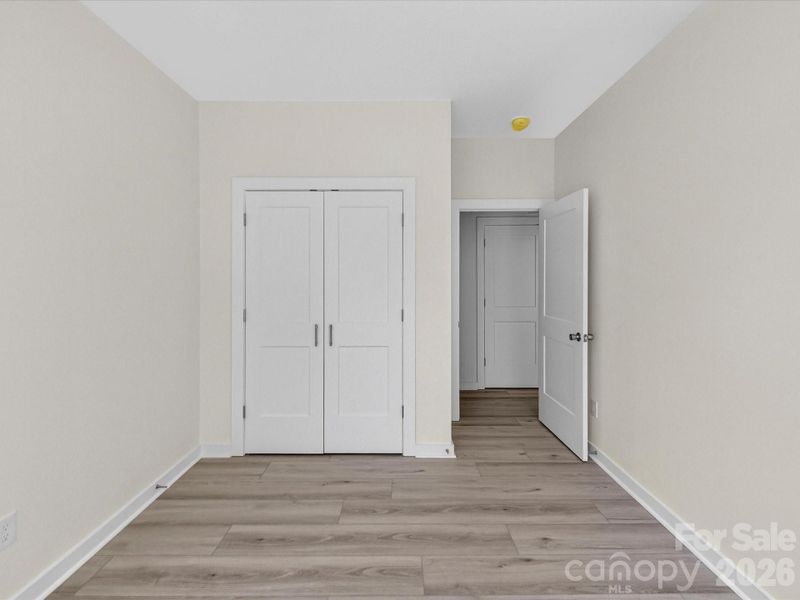 Bright secondary bedroom featuring abundant natural light, neutral finishes, and a versatile layout perfect for guests, family, or a home office. Bright secondary bedroom featuring abundant natural light, neutral finishes, and a versatile layout perfect for guests, family, or a home office.