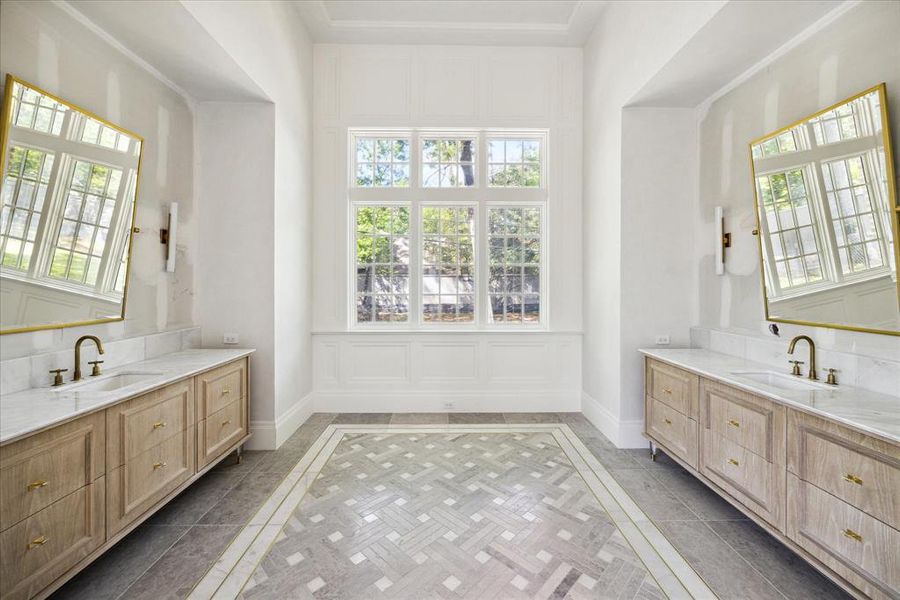 The primary bathroom also features dual vanities with plenty of under cabinet storage space.