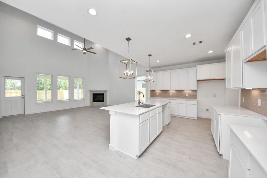 The open concept effortlessly connects the kitchen to the expansive family room, forming a perfect hub for gatherings. This seamless flow creates an inviting space where cooking and socializing come together harmoniously. Sample photo of completed home with similar floor plan. Actual colors and selections may vary. The open concept effortlessly connects the kitchen to the expansive family room, forming a perfect hub for gatherings. This seamless flow creates an inviting space where cooking and socializing come together harmoniously. Sample photo of completed home with similar floor plan. Actual colors and selections may vary.