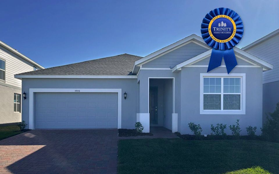 Front exterior of a new home in Trinity Place, St. Cloud, FL, highlighting curb appeal (Image 10). Front exterior of a new home in Trinity Place, St. Cloud, FL, highlighting curb appeal (Image 10).
