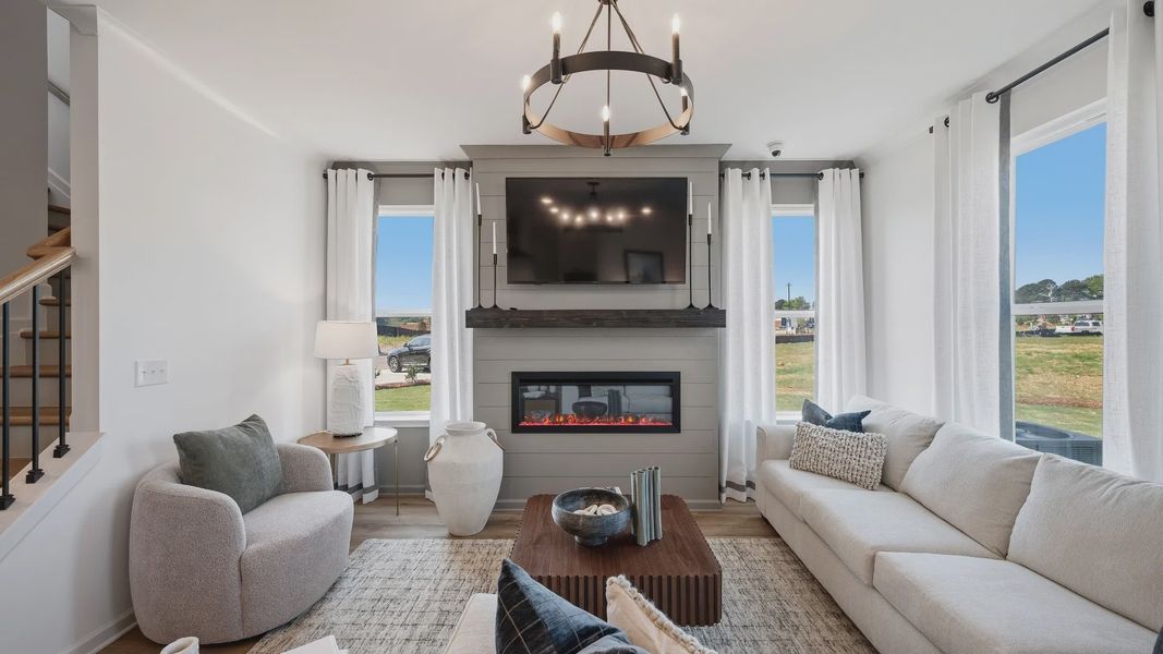Inviting family room with open concept design and abundant daylight in new construction townhome in Loganville, GA. Inviting family room with open concept design and abundant daylight in new construction townhome in Loganville, GA.