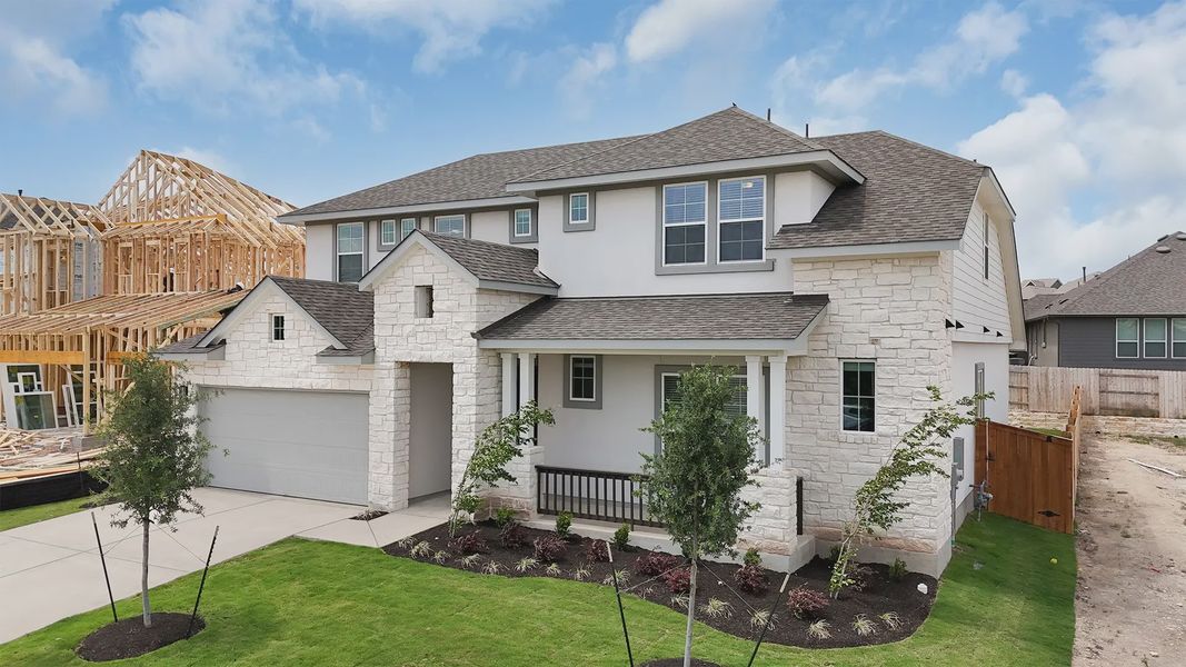 Front exterior of a new home in Lariat, Liberty Hill, TX, highlighting curb appeal (Image 21). Front exterior of a new home in Lariat, Liberty Hill, TX, highlighting curb appeal (Image 21).