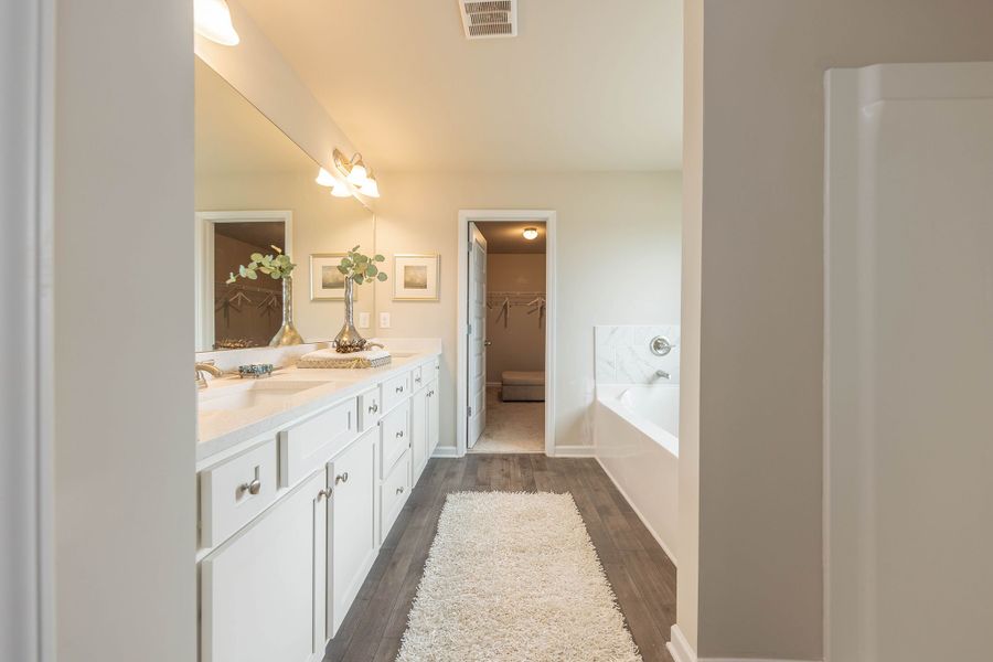 Primary bathroom with dual vanities and lots of cabinet space