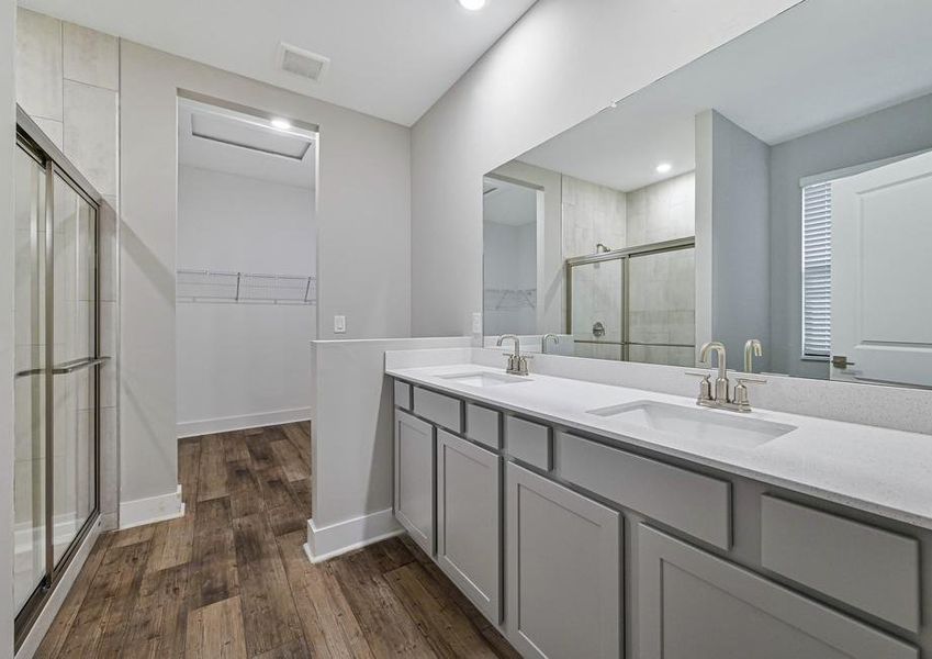 The master retreat features its own full bathroom with a double-sink vanity, a step-in shower and a sizable walk-in closet.