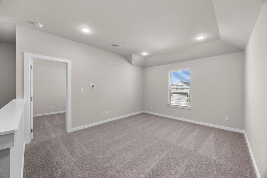 A versatile open loft space offers potential for various living arrangements, highlighted by a window bringing in natural illumination. A versatile open loft space offers potential for various living arrangements, highlighted by a window bringing in natural illumination.