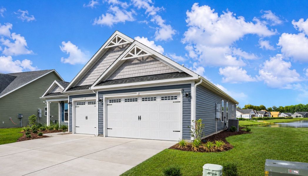 Front exterior of a new home in Traditions at Carolina Forest, Myrtle Beach, SC, highlighting curb appeal (Image 1). Front exterior of a new home in Traditions at Carolina Forest, Myrtle Beach, SC, highlighting curb appeal (Image 1).