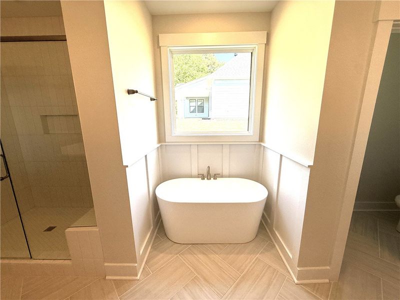 This spacious bathroom provides a serene retreat,