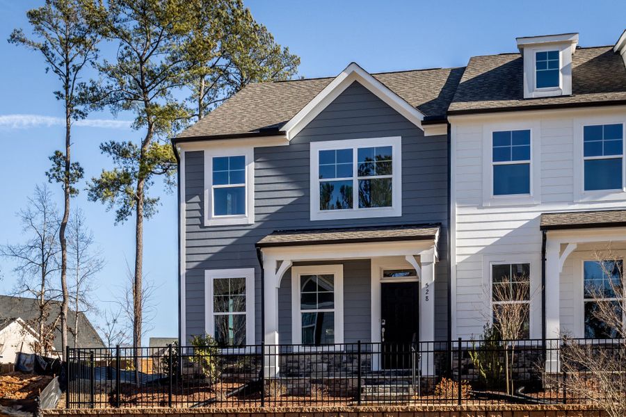 Front exterior of a new home in Enclave at Traditions Townhomes, Wake Forest, NC, highlighting curb appeal (Image 5). Front exterior of a new home in Enclave at Traditions Townhomes, Wake Forest, NC, highlighting curb appeal (Image 5).
