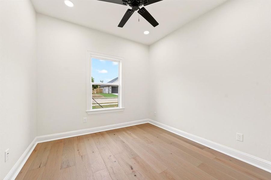 Room featuring wood-finish flooring, a ceiling fan, recessed lighting, white baseboards, and a window with white trim