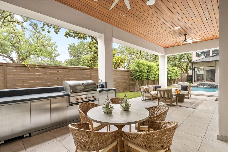 Thoughtfully designed outdoor entertaining space with kitchen, dining, and lounge areas connected to the pool