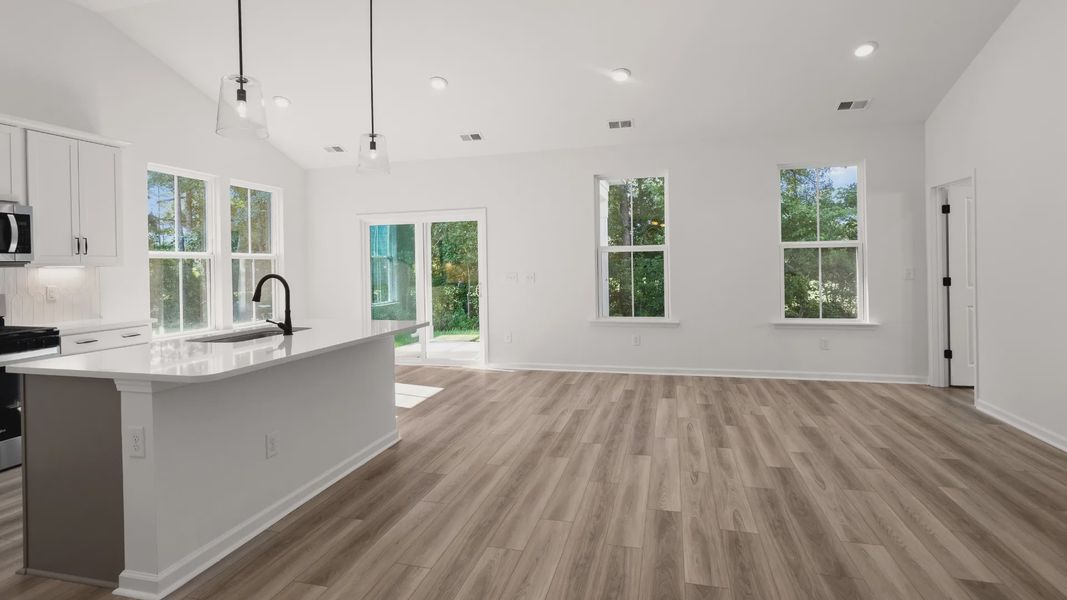 Spacious open-concept design with vaulted ceilings and bright natural light