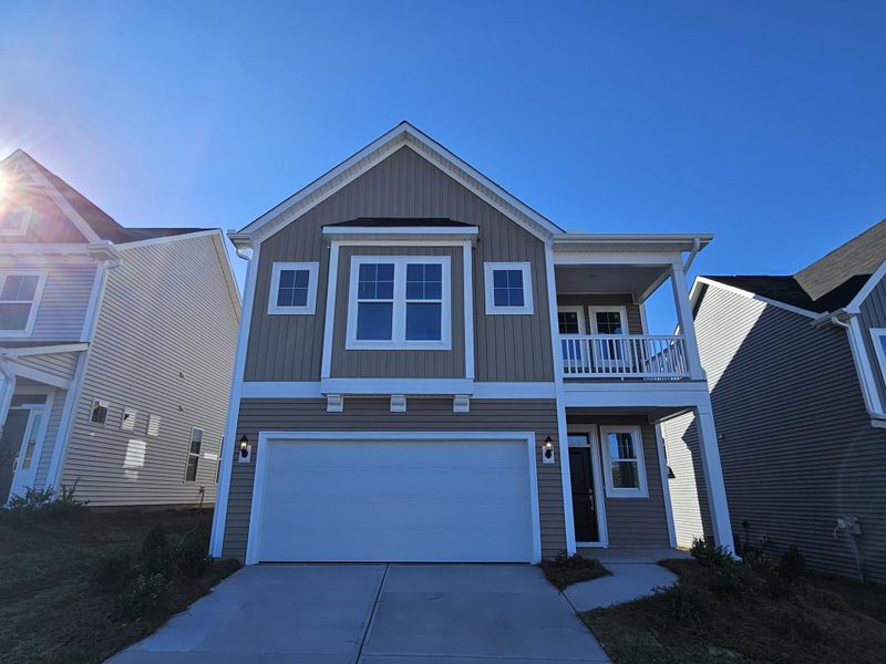 Front exterior of a new home in Renaissance at White Oak, Garner, NC, highlighting curb appeal (Image 1).