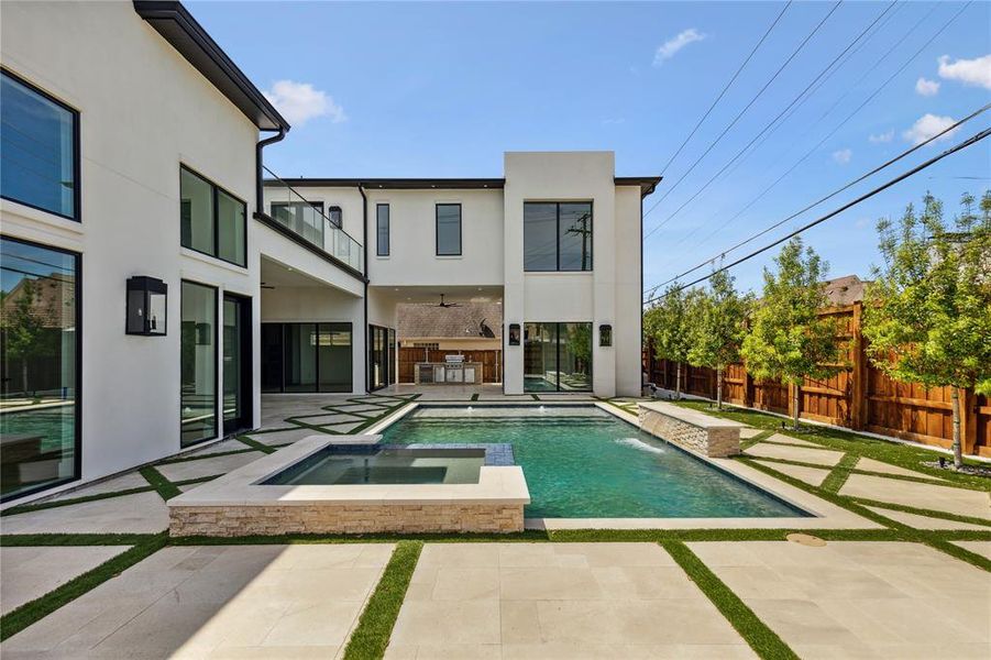 View of pool featuring pool water feature, an in ground hot tub, and a patio