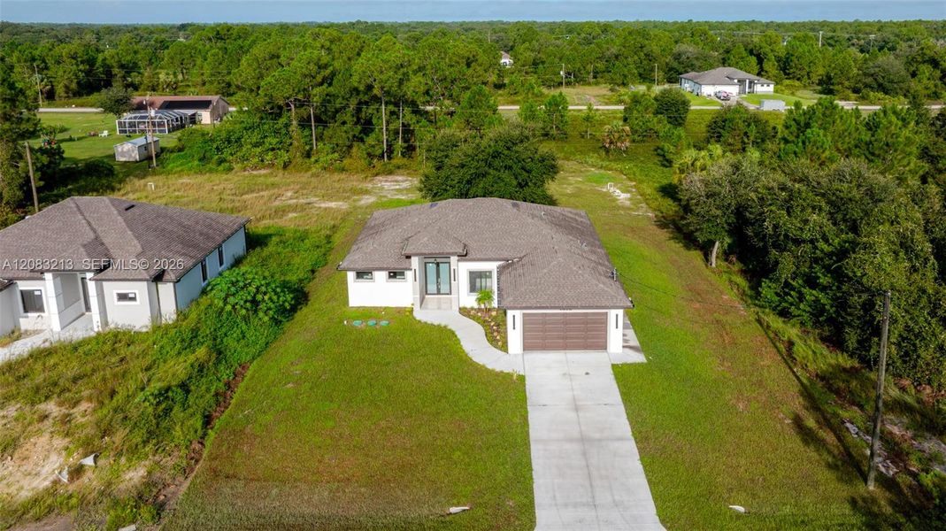 Front exterior of a new home in , Lehigh Acres, FL, highlighting curb appeal (Image 26).