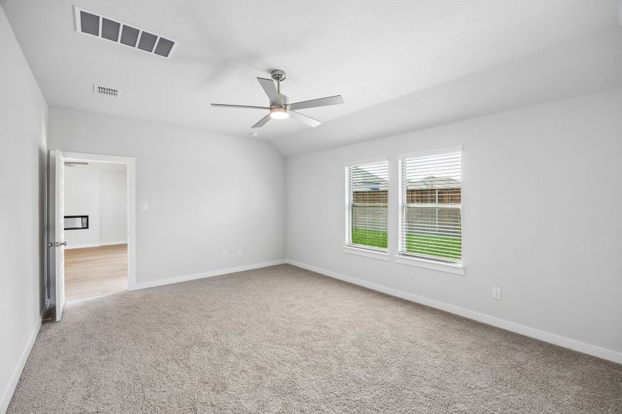 Primary Suite in the Oscar home plan by Trophy Signature Homes – REPRESENTATIVE PHOTO