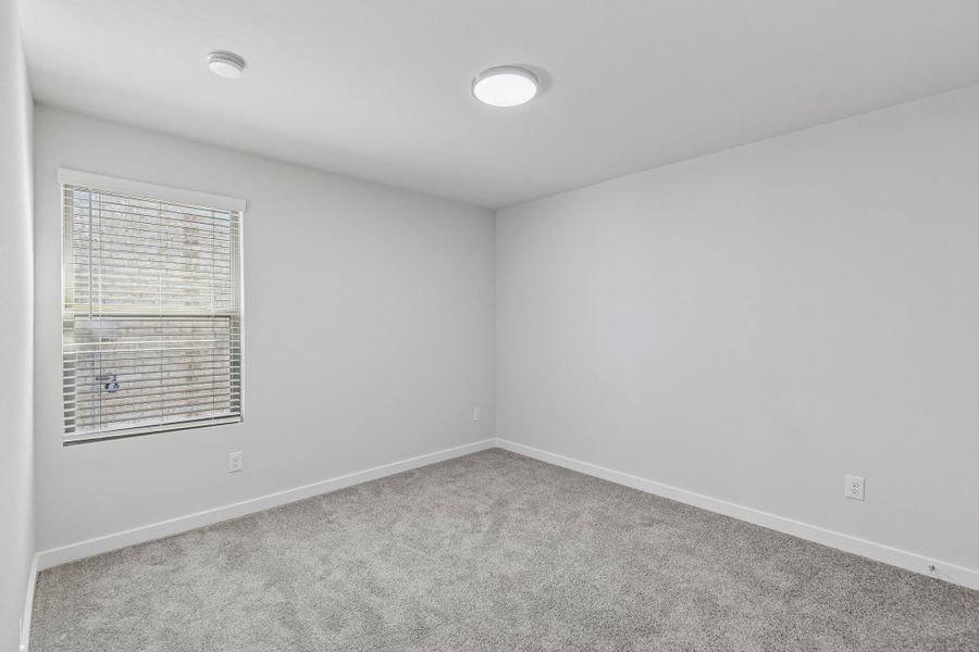 Bedroom in the Harrison home plan by Trophy Signature Homes – REPRESENTATIVE PHOTO