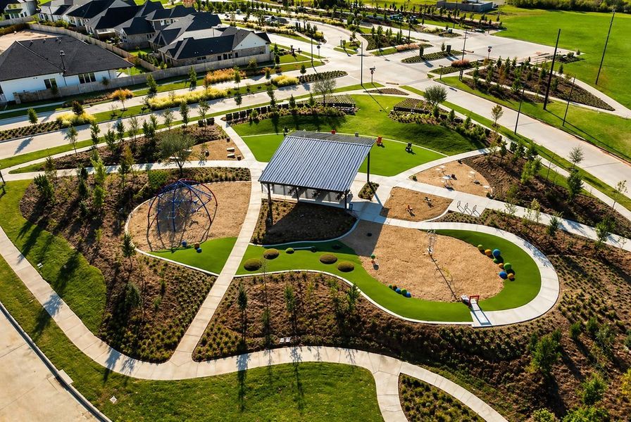 Neighborhood park space in Grange featuring a covered pavilion, playground areas, and interconnected walking trails, all set within landscaped green space designed for outdoor recreation and gathering.