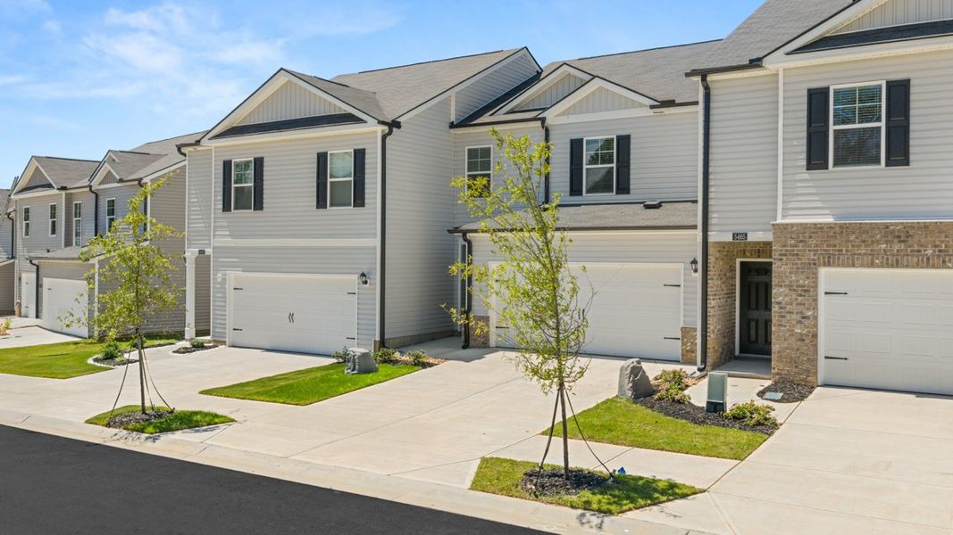 Front exterior of a new home in Rushing Waters Townhomes, North Augusta, SC, highlighting curb appeal (Image 1). Front exterior of a new home in Rushing Waters Townhomes, North Augusta, SC, highlighting curb appeal (Image 1).