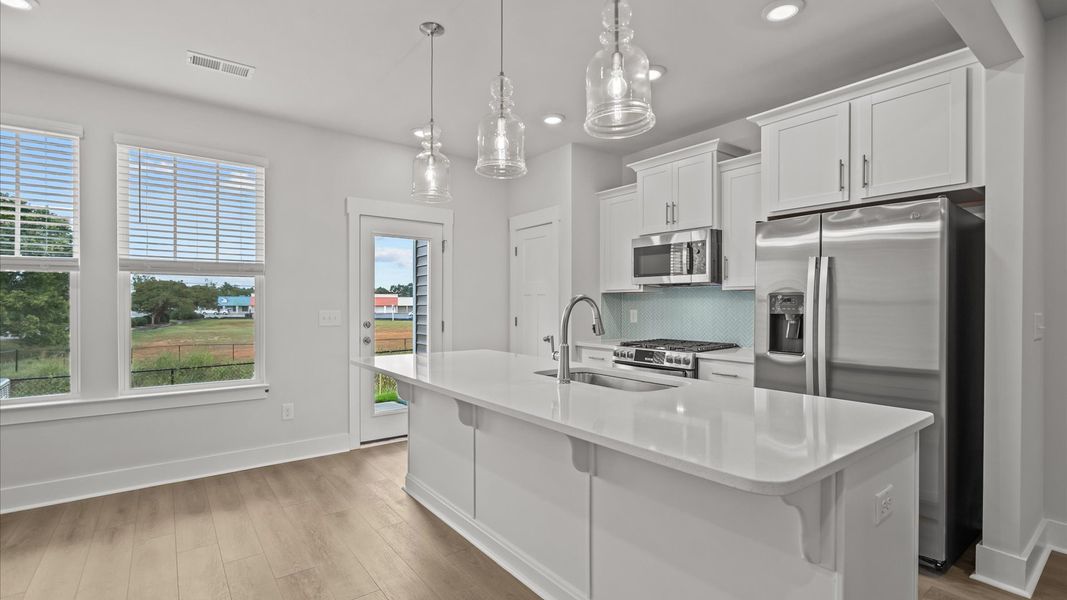 Exceptional culinary space with a striking 9-foot island and eye-catching pendant lights