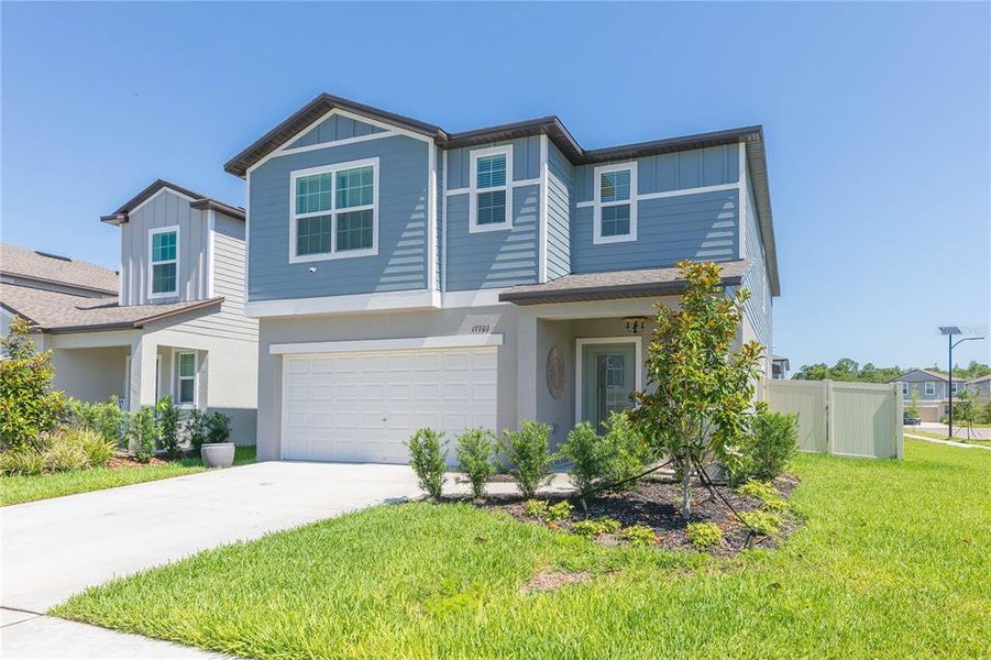Front exterior of a new home in Angeline, Land O' Lakes, FL, highlighting curb appeal (Image 2).