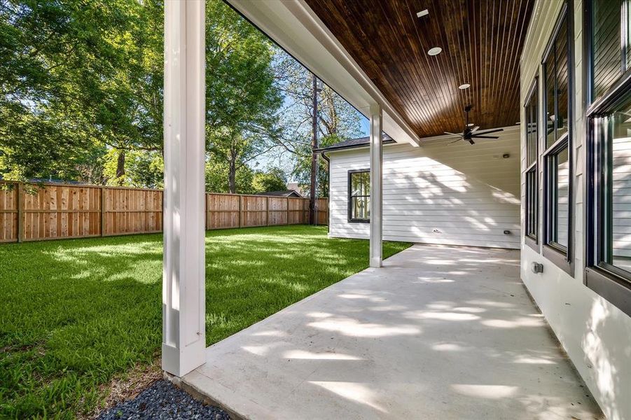 Massive covered back patio with tongue and groove ceiling