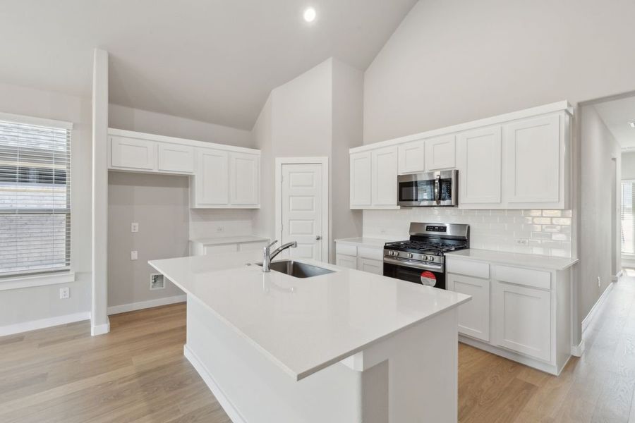 Kitchen in the Claret home plan by Trophy Signature Homes – REPRESENTATIVE PHOTO