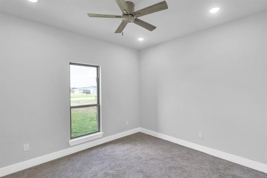 Carpeted empty room with recessed lighting and ceiling fan