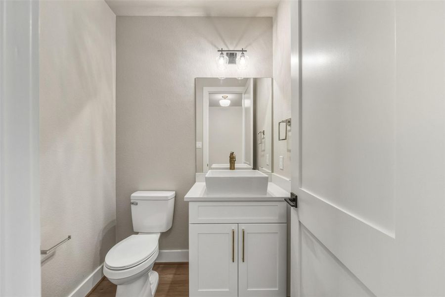 Experience modern elegance in this first-floor powder bathroom, featuring sleek fixtures and a chic design. Experience modern elegance in this first-floor powder bathroom, featuring sleek fixtures and a chic design.