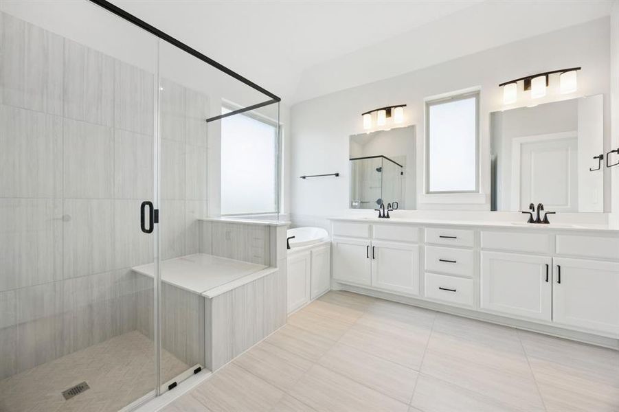 Full bathroom with a stall shower, double vanity, and light tile patterned flooring