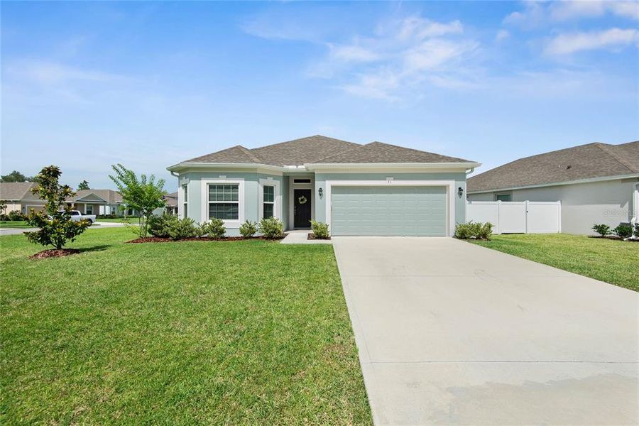 Front exterior of a new home in Sawmill Creek at Palm Coast Park, Palm Coast, FL, highlighting curb appeal (Image 27). Front exterior of a new home in Sawmill Creek at Palm Coast Park, Palm Coast, FL, highlighting curb appeal (Image 27).