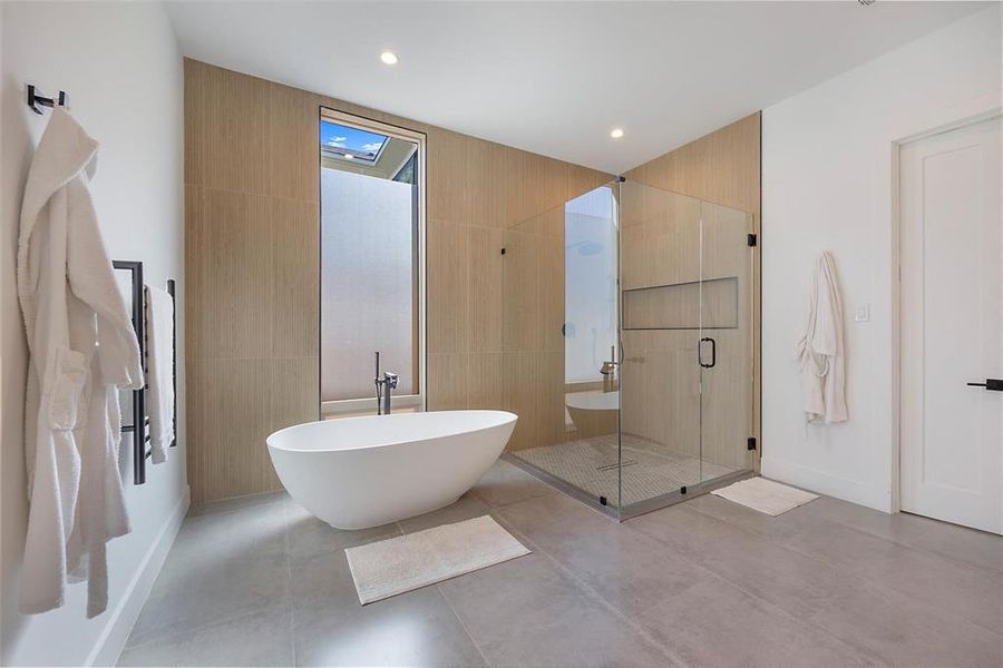 Bathroom with concrete floors and shower with separate bathtub