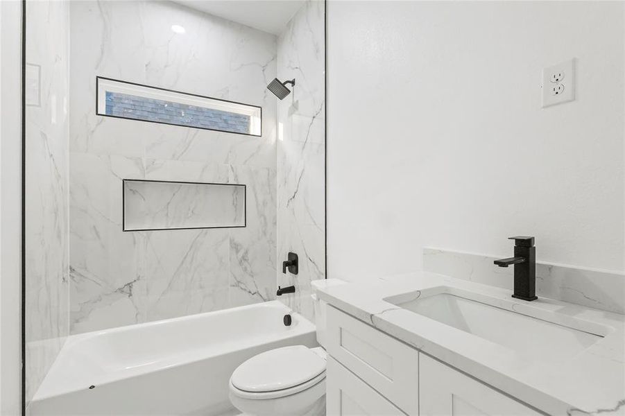 Bathroom featuring vanity and shower / tub combination Bathroom featuring vanity and shower / tub combination