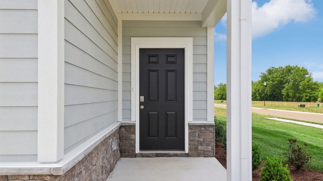 Covered Entryway to home with black door
