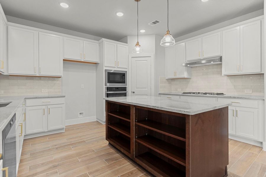 The heart of the home shines in this elegant kitchen featuring sleek white shaker cabinets, gorgeous granite countertops, and a rich contrast island that offers both workspace and style. Perfect for meal prep or casual gatherings! The heart of the home shines in this elegant kitchen featuring sleek white shaker cabinets, gorgeous granite countertops, and a rich contrast island that offers both workspace and style. Perfect for meal prep or casual gatherings!
