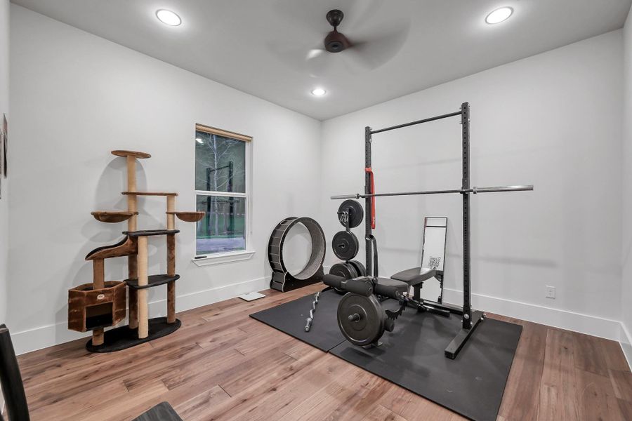 This photo showcases a massive laundry room with ample cabinetry, a Knotty Alder wooden door. Offering a functional and stylish space for household tasks.