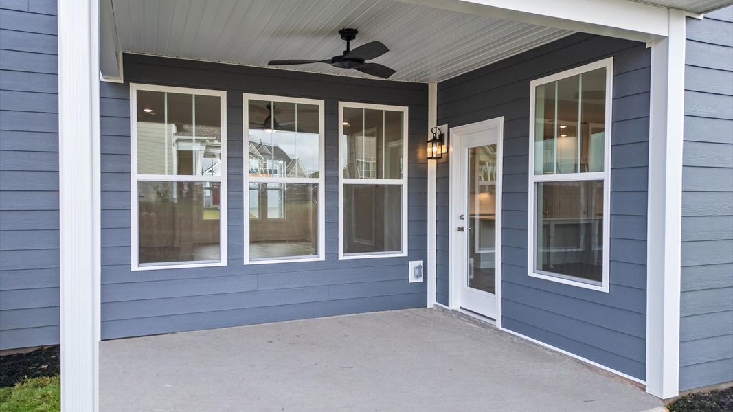 Rear covered porch offers a private, first-rate setting for outdoor enjoyment