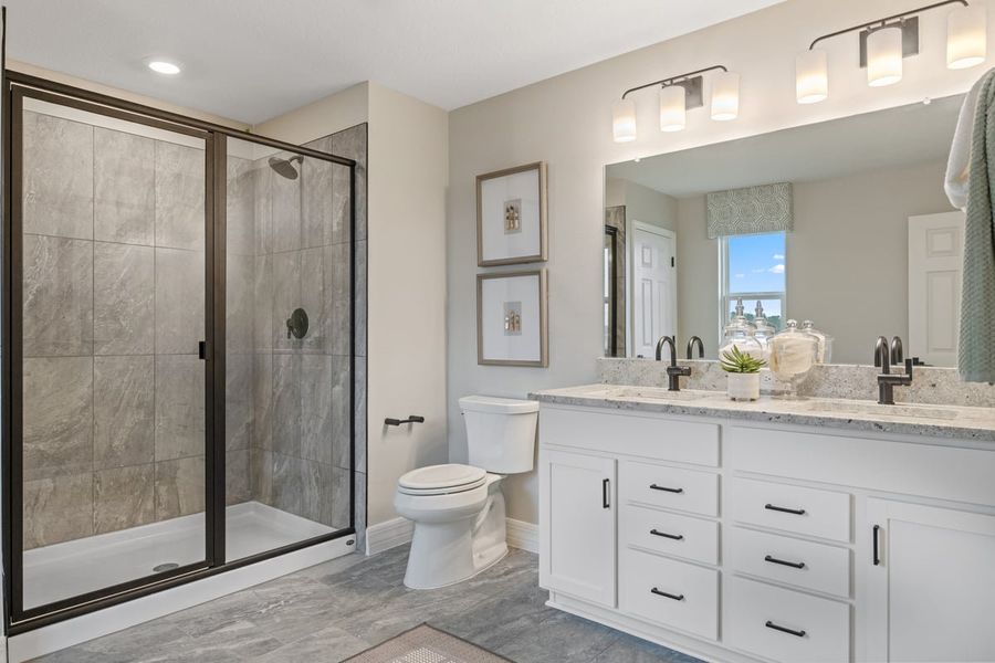 Walk-in shower with tile surround at primary bath
