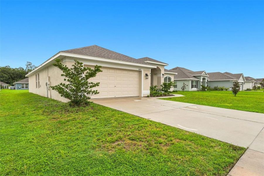 Front exterior of a new home in Knights Landing, Lakeland, FL, highlighting curb appeal (Image 23). Front exterior of a new home in Knights Landing, Lakeland, FL, highlighting curb appeal (Image 23).