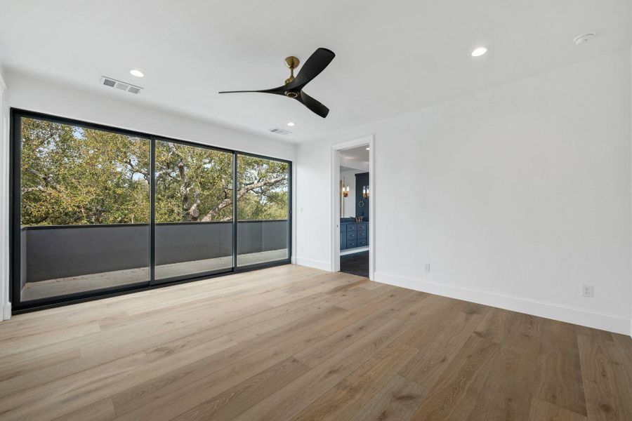 Unfurnished bedroom with light wood-style floors, ceiling fan, and recessed lighting