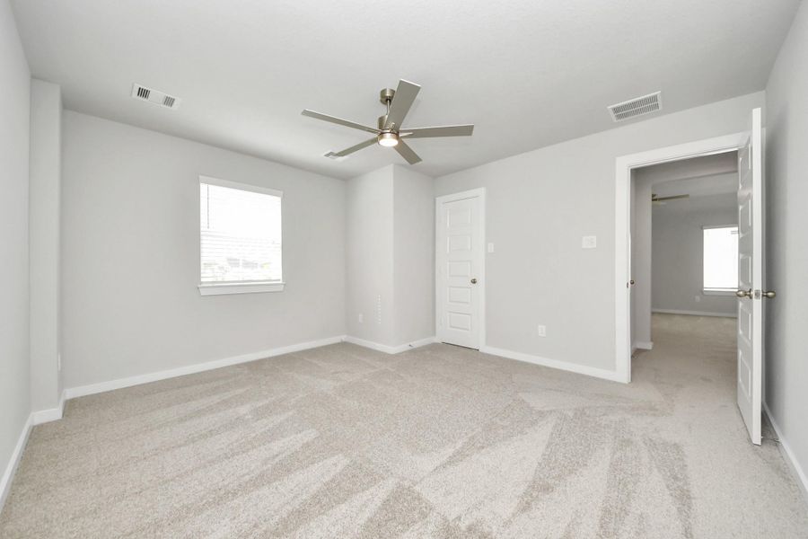 Generously sized secondary bedrooms featuring spacious closets, soft and inviting carpeting underfoot, large windows allowing plenty of natural light, and the added touch of privacy blinds for your personal retreat.