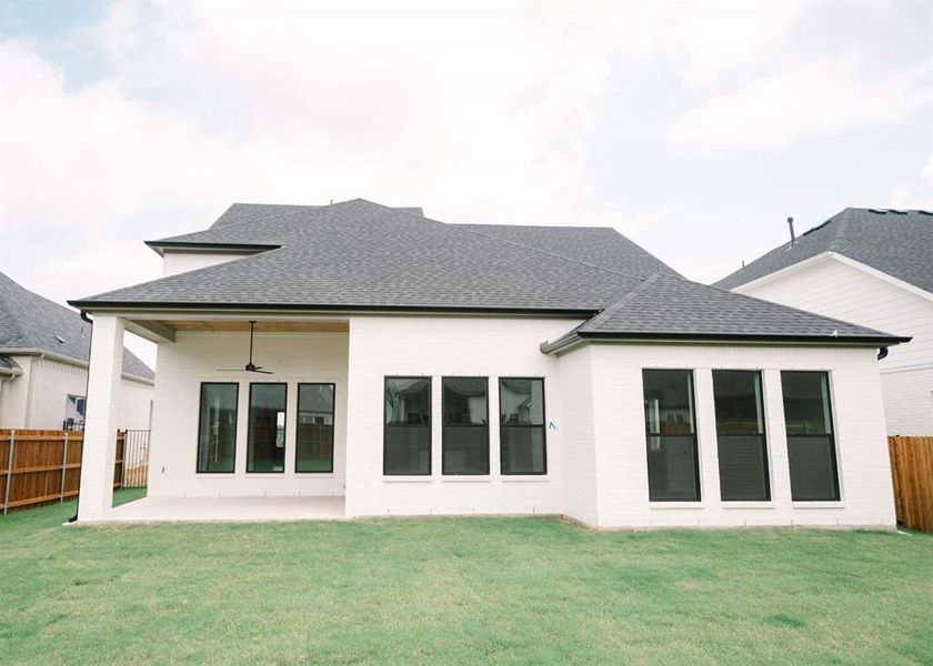 Back of property with a patio, a yard, and ceiling fan